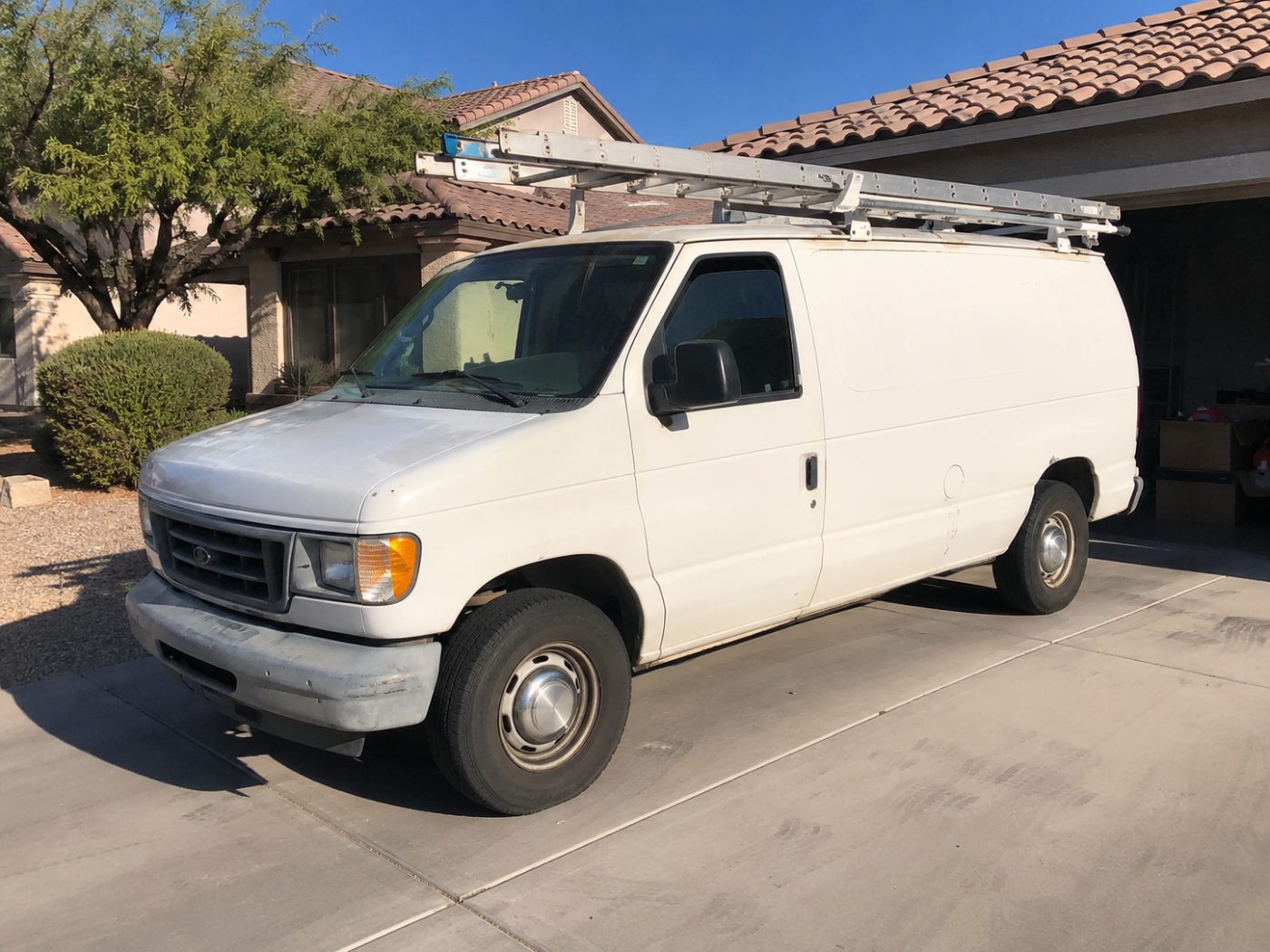 The AL-CO Electric work van with ladder rack in a Phoenix driveway
